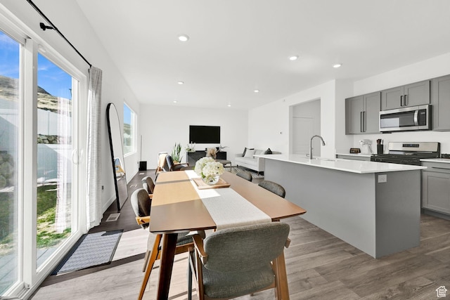 dining room featuring a wealth of natural light, recessed lighting, and light wood-style floors