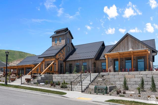 exterior space featuring a standing seam roof, stairs, and metal roof