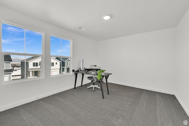 office featuring baseboards, visible vents, and carpet