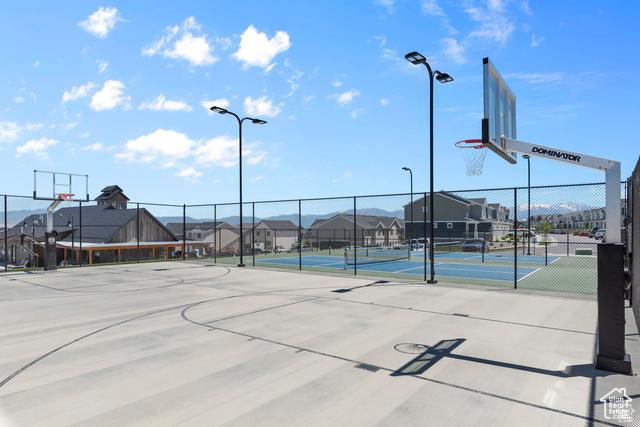 view of sport court with community basketball court, fence, and a residential view