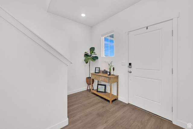 entryway with baseboards, recessed lighting, and light wood finished floors