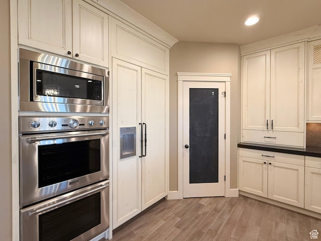 1663 N 3500 W, Plain City, UT 84404 - kitchen featuring stainless steel appliances, light wood-type flooring, dark countertops, and recessed lighting