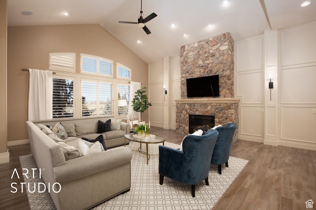 1663 N 3500 W, Plain City, UT 84404 - living room with high vaulted ceiling, a fireplace, wood finished floors, and a decorative wall