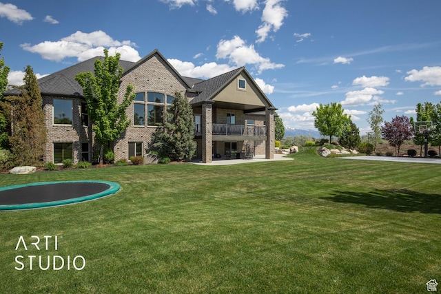 1663 N 3500 W, Plain City, UT 84404 - rear view of house with brick siding, a lawn, a balcony, and a patio