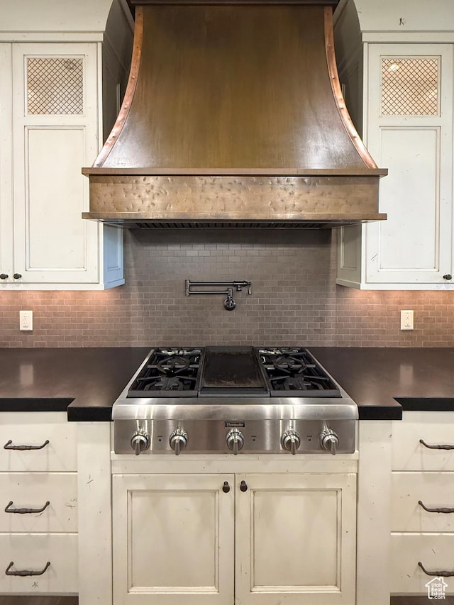 1663 N 3500 W, Plain City, UT 84404 - kitchen with stainless steel gas cooktop, tasteful backsplash, dark countertops, and custom range hood