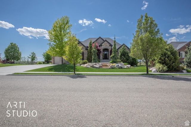 1663 N 3500 W, Plain City, UT 84404 - view of front of property featuring a garage, stone siding, a front lawn, and driveway