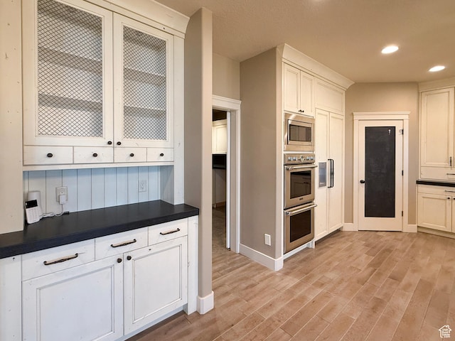 1663 N 3500 W, Plain City, UT 84404 - kitchen with white cabinets, dark countertops, stainless steel appliances, light wood-type flooring, and recessed lighting
