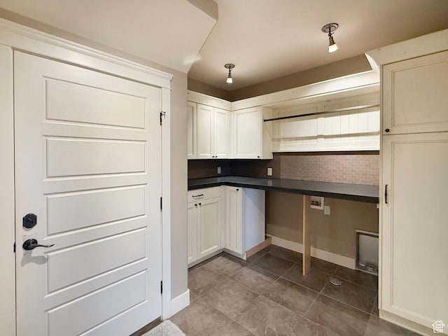 1663 N 3500 W, Plain City, UT 84404 - kitchen with dark countertops, white cabinetry, and baseboards