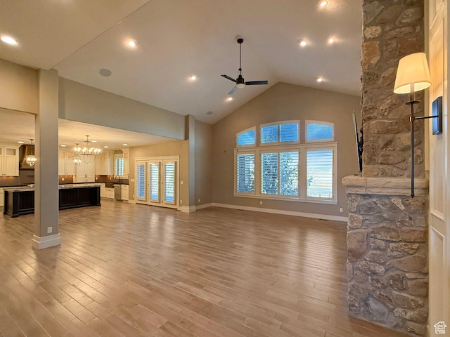 1663 N 3500 W, Plain City, UT 84404 - living area featuring high vaulted ceiling, recessed lighting, ceiling fan with notable chandelier, wood finished floors, and baseboards