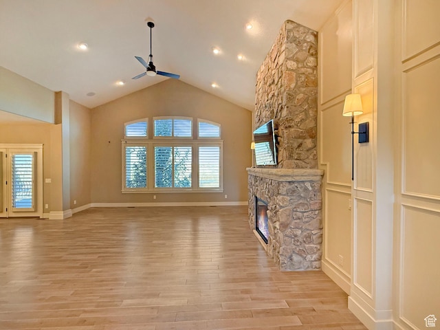 1663 N 3500 W, Plain City, UT 84404 - unfurnished living room featuring light wood-style floors, baseboards, a ceiling fan, and a stone fireplace