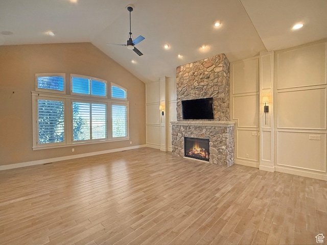 1663 N 3500 W, Plain City, UT 84404 - unfurnished living room with a fireplace, light wood finished floors, a decorative wall, ceiling fan, and baseboards