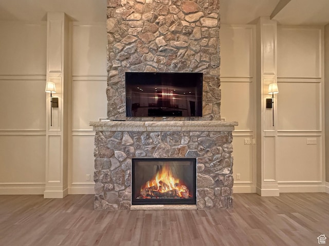 1663 N 3500 W, Plain City, UT 84404 - interior details with a fireplace, a decorative wall, and wood finished floors