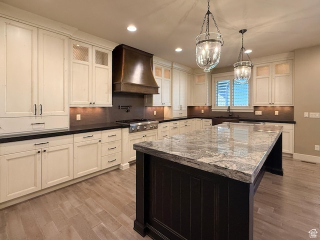 1663 N 3500 W, Plain City, UT 84404 - kitchen with custom exhaust hood, decorative backsplash, light wood finished floors, glass insert cabinets, and stainless steel gas stovetop