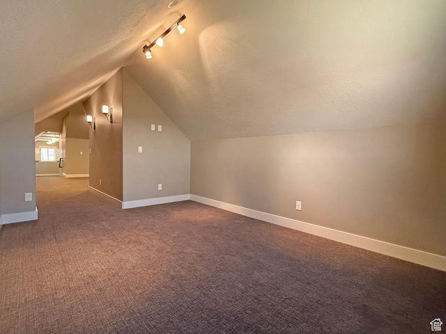 1663 N 3500 W, Plain City, UT 84404 - bonus room with dark carpet, baseboards, vaulted ceiling, and a textured ceiling