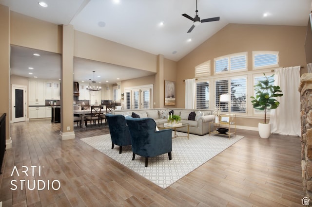 1663 N 3500 W, Plain City, UT 84404 - living room featuring high vaulted ceiling, wood finished floors, and ceiling fan with notable chandelier