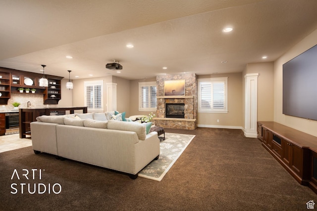 1663 N 3500 W, Plain City, UT 84404 - carpeted living area with wine cooler, indoor wet bar, recessed lighting, a stone fireplace, and baseboards