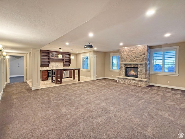 1663 N 3500 W, Plain City, UT 84404 - unfurnished living room with a fireplace, baseboards, and dark colored carpet