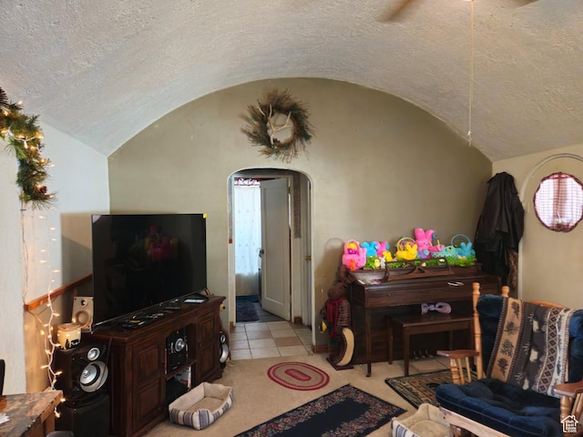 613 Jefferson St, Montpelier, ID 83254 - tiled living room featuring arched walkways, lofted ceiling, and a textured ceiling