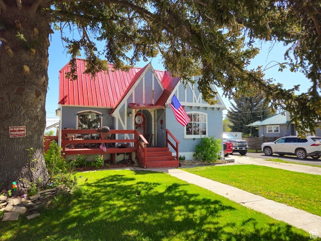 613 Jefferson St, Montpelier, ID 83254 - tudor home featuring metal roof, a front lawn, and concrete driveway