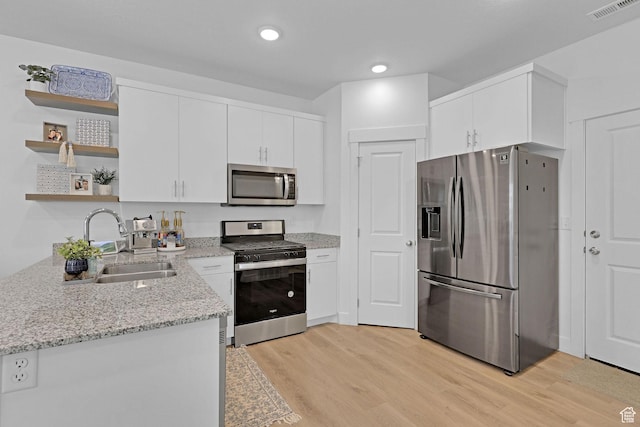 1189 W 1820 S Unit 13, Logan, UT 84321 - kitchen with appliances with stainless steel finishes, a sink, open shelves, light wood-style flooring, and recessed lighting