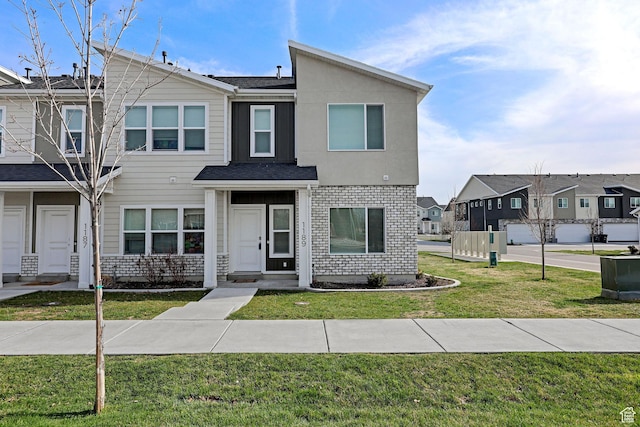 1189 W 1820 S Unit 13, Logan, UT 84321 - townhome / multi-family property featuring a residential view, a front lawn, brick siding, and a shingled roof