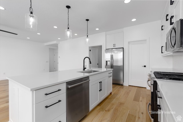 4085 E El Capitan Way, St George, UT 84790 - kitchen with a sink, light wood-type flooring, appliances with stainless steel finishes, recessed lighting, and a center island with sink