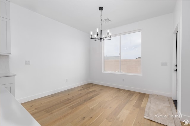 4085 E El Capitan Way, St George, UT 84790 - unfurnished dining area featuring a chandelier, light wood-type flooring, baseboards, and visible vents