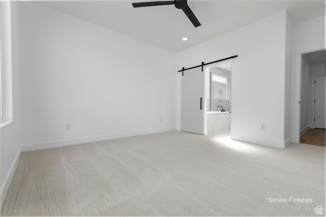 4085 E El Capitan Way, St George, UT 84790 - unfurnished bedroom featuring baseboards, a barn door, recessed lighting, ensuite bath, and light colored carpet
