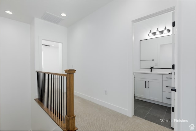 4085 E El Capitan Way, St George, UT 84790 - hallway with recessed lighting, carpet flooring, an upstairs landing, visible vents, and a sink