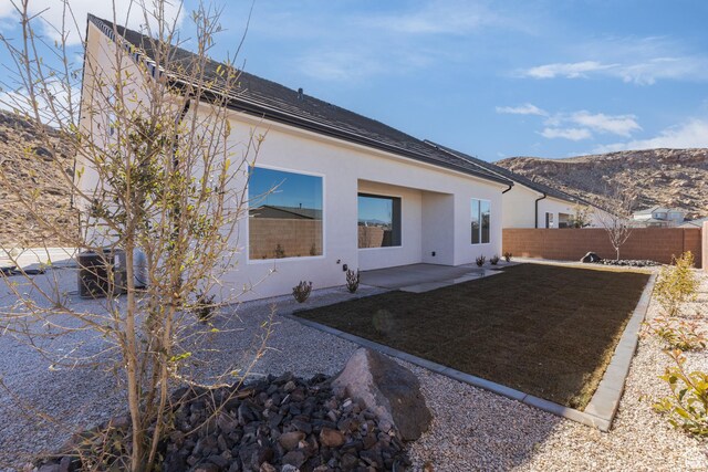 4085 E El Capitan Way, St George, UT 84790 - back of property featuring a patio area, a mountain view, fence, and stucco siding