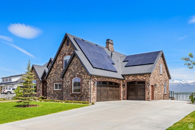 1698 S Amanda Ln E, Saratoga Springs, UT 84045 - view of front facade with a chimney, a front yard, fence, a garage, and driveway