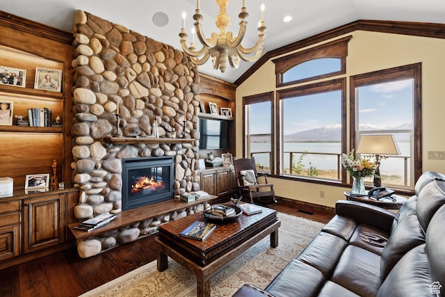 1698 S Amanda Ln E, Saratoga Springs, UT 84045 - living area featuring built in shelves, vaulted ceiling, a stone fireplace, wood finished floors, and a chandelier