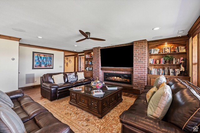 1698 S Amanda Ln E, Saratoga Springs, UT 84045 - living area featuring light wood-style flooring, crown molding, built in shelves, a fireplace, and recessed lighting