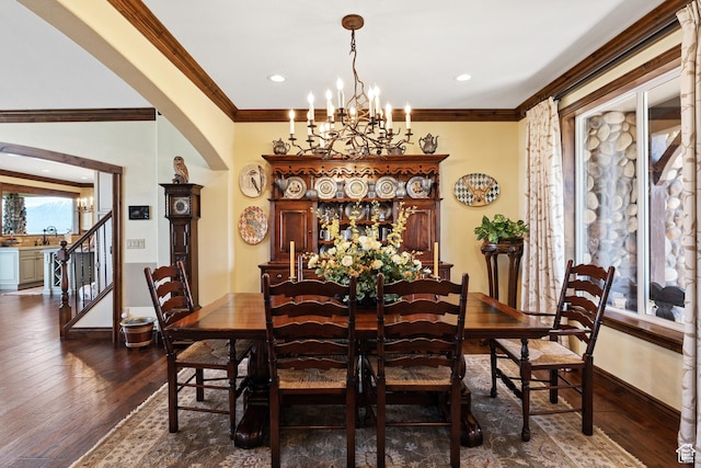 1698 S Amanda Ln E, Saratoga Springs, UT 84045 - dining area featuring arched walkways, a chandelier, baseboards, dark wood finished floors, and crown molding