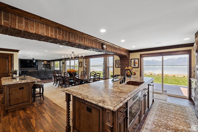 1698 S Amanda Ln E, Saratoga Springs, UT 84045 - kitchen featuring a water view, a kitchen island with sink, a breakfast bar area, and a sink