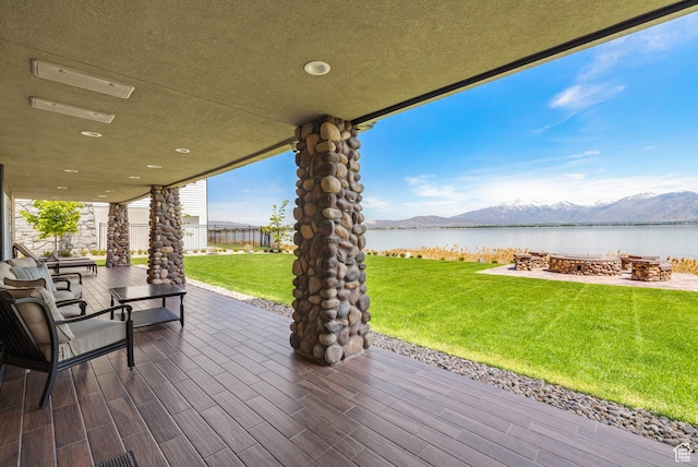 1698 S Amanda Ln E, Saratoga Springs, UT 84045 - wooden terrace featuring a lawn, a fire pit, and a water and mountain view