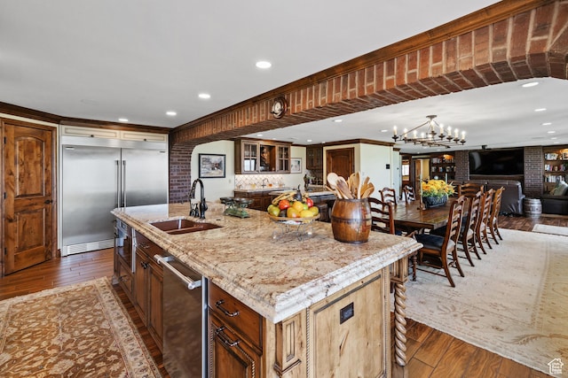 1698 S Amanda Ln E, Saratoga Springs, UT 84045 - kitchen featuring stainless steel appliances, wood-type flooring, a sink, and light stone counters