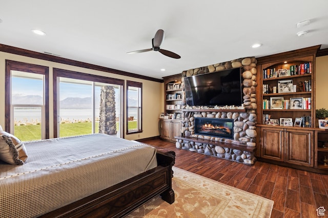 1698 S Amanda Ln E, Saratoga Springs, UT 84045 - bedroom with dark wood-style flooring, crown molding, a fireplace, recessed lighting, and ceiling fan