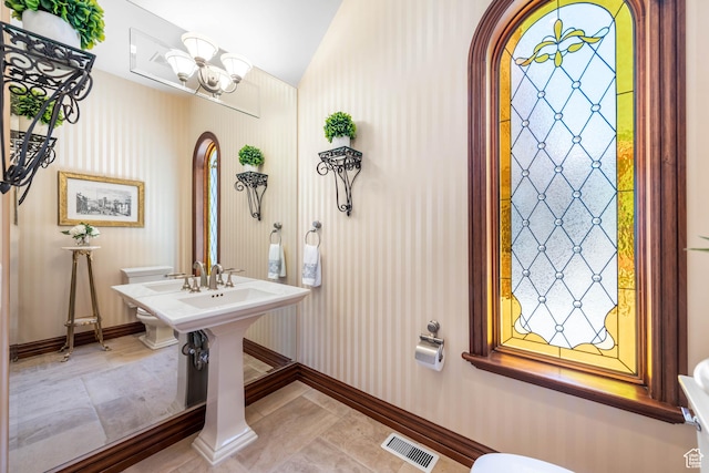 290 E 200 S, Parowan, UT 84761 - bathroom featuring baseboards, visible vents, lofted ceiling, tile patterned flooring, and a notable chandelier