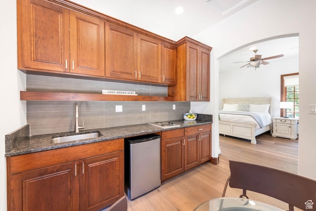 290 E 200 S, Parowan, UT 84761 - kitchen featuring a sink, light wood-type flooring, dishwasher, open shelves, and brown cabinetry