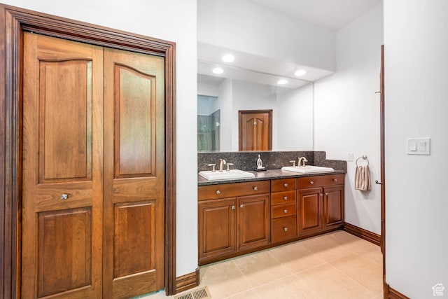 290 E 200 S, Parowan, UT 84761 - bathroom with double vanity, tile patterned flooring, a sink, and decorative backsplash