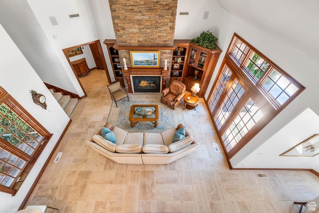 290 E 200 S, Parowan, UT 84761 - living room featuring a lit fireplace, a high ceiling, visible vents, and baseboards