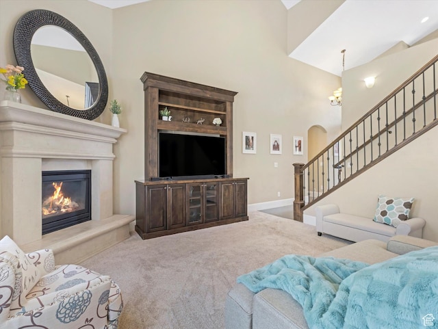 5204 N Eagles View Dr N, Lehi, UT 84043 - carpeted living area featuring stairs, a towering ceiling, a chandelier, a premium fireplace, and baseboards