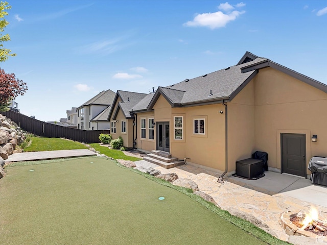 5204 N Eagles View Dr N, Lehi, UT 84043 - back of property with a putting green, an outdoor fire pit, french doors, stucco siding, and a patio area