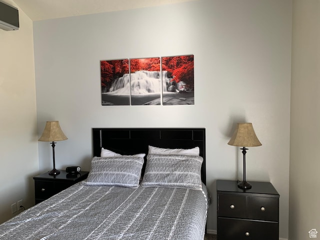 bedroom featuring a wall unit AC