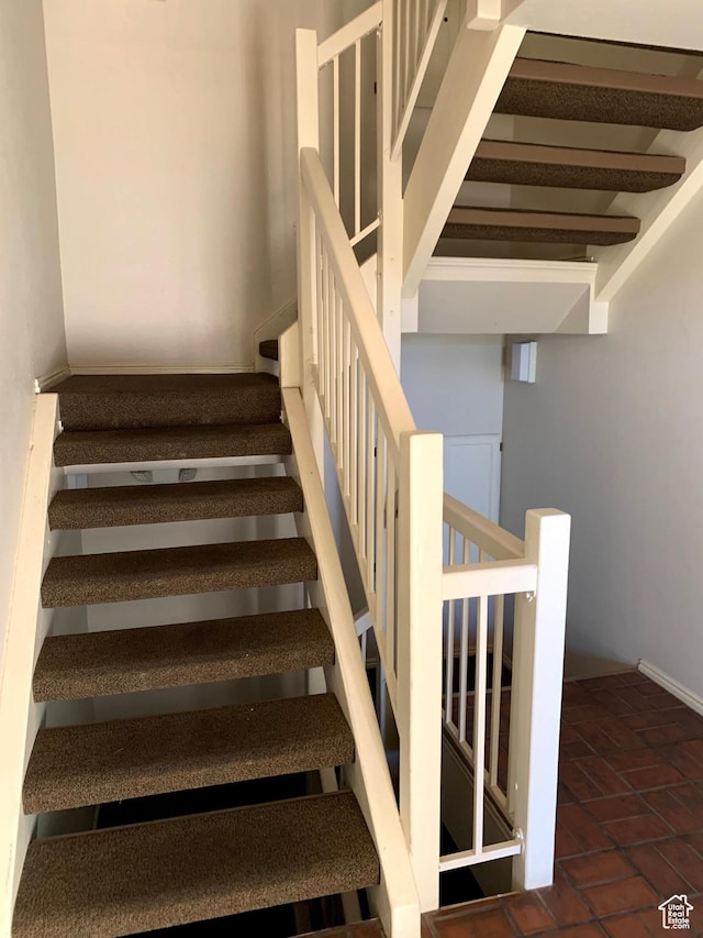 stairs featuring brick floor