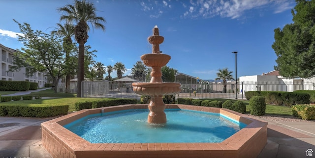 view of swimming pool with a residential view and fence