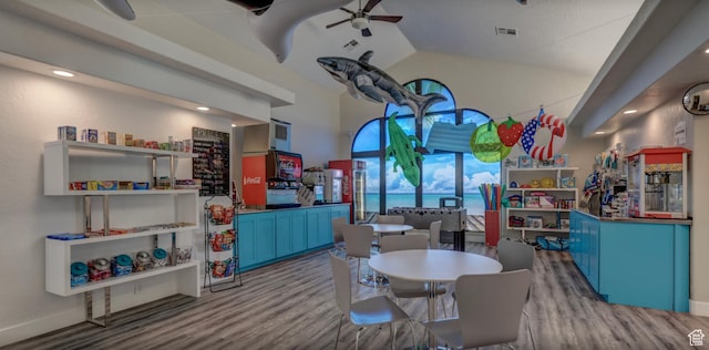 recreation room with vaulted ceiling, visible vents, ceiling fan, and wood finished floors