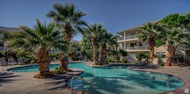 pool with fence and a patio
