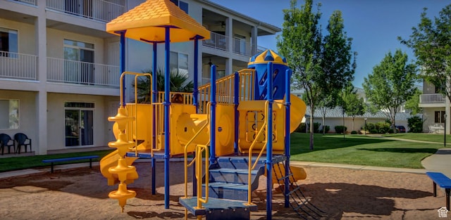 community jungle gym featuring a lawn